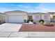 Inviting single-story home features a manicured front yard, complemented by an attached two-car garage at 3015 Extravagant Ave, North Las Vegas, NV 89031