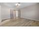 Spacious bedroom featuring neutral walls and wood-look floors, with doors to a closet and hallway at 3916 S Torrey Pines Dr, Las Vegas, NV 89103