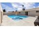 Backyard pool area with a hot tub and pool, adjacent to the house with a sliding door for easy access at 3916 S Torrey Pines Dr, Las Vegas, NV 89103