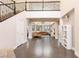 Grand foyer with soaring ceilings, iron staircase, shiny concrete floors, and an open view to the living room at 3934 Sangre De Cristo Ave, Las Vegas, NV 89118