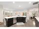 Bright kitchen features a large island with quartz countertops, stainless appliances, and dark wood cabinetry at 3934 Sangre De Cristo Ave, Las Vegas, NV 89118