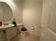 Cozy bathroom featuring a pedestal sink and toilet at 3936 Pepper Thorn Ave # 102, North Las Vegas, NV 89081