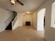 Open-concept living room with tile flooring, stairway, and an arched doorway at 3936 Pepper Thorn Ave # 102, North Las Vegas, NV 89081