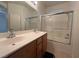 This bathroom features double sinks, wood cabinets and a shower-tub combination at 3936 Pepper Thorn Ave # 102, North Las Vegas, NV 89081