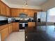 Updated kitchen with stainless steel appliances, granite countertops, and wooden cabinetry at 3936 Pepper Thorn Ave # 102, North Las Vegas, NV 89081