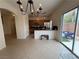 Bright dining area with access to kitchen, stainless steel appliances, and outdoor patio at 3936 Pepper Thorn Ave # 102, North Las Vegas, NV 89081