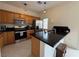 Modern kitchen featuring stainless steel appliances, granite countertops, and wood cabinets at 3936 Pepper Thorn Ave # 102, North Las Vegas, NV 89081