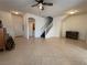 Open-concept living area with tile flooring, natural light, and staircase access at 3936 Pepper Thorn Ave # 102, North Las Vegas, NV 89081