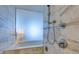 Elegant bathroom with a glass-enclosed tub/shower featuring modern fixtures and tiled walls at 4381 W Flamingo Rd # 1510, Las Vegas, NV 89103