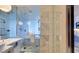Sleek bathroom showcasing a glass shower enclosure, marble walls, and modern fixtures at 4381 W Flamingo Rd # 1510, Las Vegas, NV 89103
