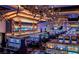 Inviting casino with rows of slot machines, bar area, and modern lighting fixtures at 4381 W Flamingo Rd # 1510, Las Vegas, NV 89103