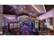 Large gaming area featuring multiple slot machines, stylish lighting and patterned carpet at 4381 W Flamingo Rd # 1510, Las Vegas, NV 89103