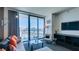 Cozy living area with a comfortable sofa, modern lighting, city views, and a stylish glass coffee table at 4381 W Flamingo Rd # 1510, Las Vegas, NV 89103