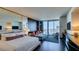 Well-appointed bedroom suite with a seating area, balcony, and city views at 4381 W Flamingo Rd # 1510, Las Vegas, NV 89103