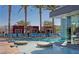 Resort-style pool area with comfortable lounge chairs, poolside cabanas, and lush palm trees at 4381 W Flamingo Rd # 1510, Las Vegas, NV 89103