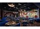 Stylish restaurant featuring blue seating, eclectic wall art, and warm lighting at 4381 W Flamingo Rd # 1510, Las Vegas, NV 89103