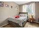 Bright bedroom with a floral comforter, bedside table and window at 4606 Engage St, North Las Vegas, NV 89031