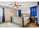 Comfortable bedroom featuring a wooden bed frame and blue curtains at 4606 Engage St, North Las Vegas, NV 89031