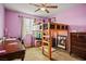 Cozy bedroom with a loft bed, desk, and dresser providing comfort and functionality at 4606 Engage St, North Las Vegas, NV 89031