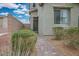 Close-up of the home's entrance with neatly trimmed bushes, a brick walkway, and a modern door at 4606 Engage St, North Las Vegas, NV 89031