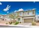 Well-kept two-story home with a paved driveway, attached garage, and manicured landscaping at 4606 Engage St, North Las Vegas, NV 89031