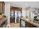 Kitchen includes stainless steel fridge, granite countertops, tile floors, and dark wood cabinets at 4606 Engage St, North Las Vegas, NV 89031