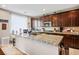 Kitchen includes granite countertops, dark wood cabinets, and a kitchen island with sink at 4606 Engage St, North Las Vegas, NV 89031
