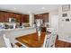 Open kitchen with granite countertops, dining table, and stainless steel appliances at 4606 Engage St, North Las Vegas, NV 89031