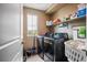 Practical laundry room with modern washer and dryer, and convenient storage shelves at 4606 Engage St, North Las Vegas, NV 89031