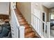 A staircase with white railings and wood-look steps leads upstairs at 4606 Engage St, North Las Vegas, NV 89031