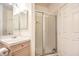 Bright bathroom features a glass shower, single sink vanity, and a crisp white door at 4679 El Camino Cabos Dr, Las Vegas, NV 89147