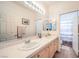 Bathroom with double sinks and an expansive mirror, providing a bright and functional space at 4679 El Camino Cabos Dr, Las Vegas, NV 89147