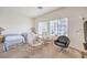 Spacious bedroom featuring two beds, lounge chairs, and natural light, offering comfort and versatility at 4679 El Camino Cabos Dr, Las Vegas, NV 89147