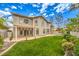 Two-story home showcasing a well-maintained backyard, patio, lawn, and lush landscaping, creating a tranquil retreat at 4679 El Camino Cabos Dr, Las Vegas, NV 89147
