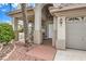 Inviting front porch with an arched doorway and well-manicured landscaping creates a welcoming entrance at 4679 El Camino Cabos Dr, Las Vegas, NV 89147