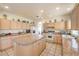 Eat-in kitchen with granite countertops, an island and ample storage space at 4679 El Camino Cabos Dr, Las Vegas, NV 89147