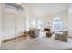 Spacious living room with large windows, fireplace, and high ceilings, perfect for entertaining guests at 4679 El Camino Cabos Dr, Las Vegas, NV 89147