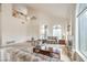 Bright and airy living room features soaring ceilings, large windows, and a cozy fireplace at 4679 El Camino Cabos Dr, Las Vegas, NV 89147
