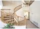Grand staircase with beautiful wood banisters leads to the upper level of the home at 4679 El Camino Cabos Dr, Las Vegas, NV 89147