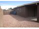 View of the back of the house with a low-maintenance rock yard and block wall fencing at 4843 Lana Dr, Las Vegas, NV 89121