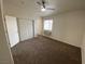 Carpeted bedroom with a closet and window, bathed in natural light at 4843 Lana Dr, Las Vegas, NV 89121