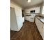 Clean kitchen featuring white cabinetry and appliances, with wood-look floors at 4843 Lana Dr, Las Vegas, NV 89121