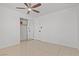 A bright bedroom with tile flooring and sliding closet doors and a ceiling fan at 488 Chelsea Dr, Henderson, NV 89014