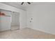 A bedroom with tile flooring and a sliding closet door and a ceiling fan at 488 Chelsea Dr, Henderson, NV 89014