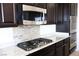 Close-up of kitchen with stainless steel microwave, cooktop, and granite countertops at 4908 Desert Lime Ct, Las Vegas, NV 89148