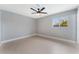 Bright bedroom features a ceiling fan and a window at 4986 Palmyra Ave, Las Vegas, NV 89146