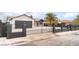 Exterior view of a charming home with a black gate and black garage door at 4986 Palmyra Ave, Las Vegas, NV 89146