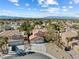 An aerial perspective highlights the home's location in a vibrant community with palm trees and mountain views at 5 Rampart Ct, Henderson, NV 89074