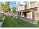Spacious backyard features artificial turf, covered patio, and plenty of room for activities at 5 Rampart Ct, Henderson, NV 89074