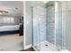 Bathroom shower with glass doors and tile, viewed from the bedroom at 5 Rampart Ct, Henderson, NV 89074